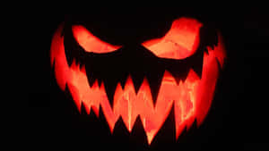 Glowing Jack O Lantern Face Darkness Wallpaper