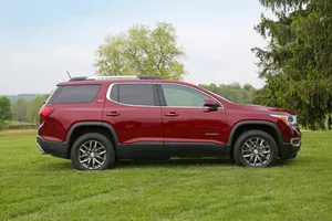 Gmc Acadia Driving On A Scenic Road Wallpaper