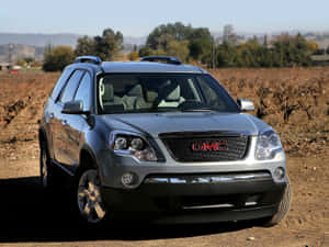 Gmc Acadia On A Scenic Mountain Road Wallpaper