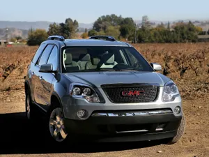 Gmc Acadia On A Scenic Mountain Road Wallpaper