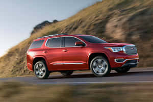 Gmc Acadia Suv Cruising Down Open Road Wallpaper