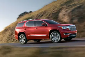Gmc Acadia Suv Cruising Down Open Road Wallpaper