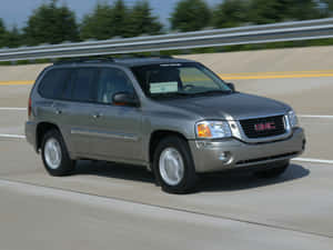 Gmc Envoy Suv On Open Road Wallpaper