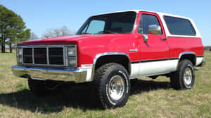 Gmc Jimmy 4x4 Suv On A Scenic Mountain Road Wallpaper