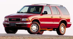 Gmc Jimmy Suv On The Road Wallpaper