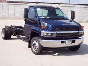 Gmc Topkick Monster Truck On A Dirt Road Wallpaper
