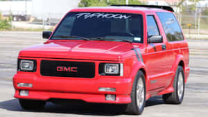 Gmc Typhoon Sprinting Down The Road Wallpaper