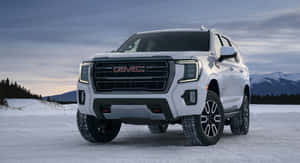 Gmc Yukon Driving On Road Wallpaper