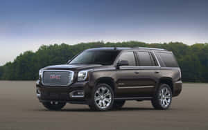 Gmc Yukon Driving On The Road Wallpaper