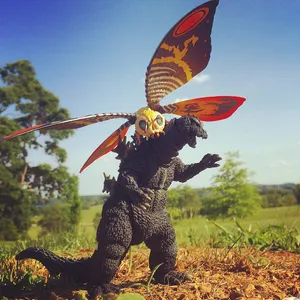 Godzilla And Mothra Locked In An Epic Battle Wallpaper