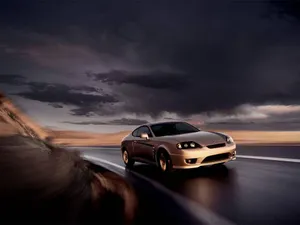 Gold Cars Driving On Cloudy Night Wallpaper