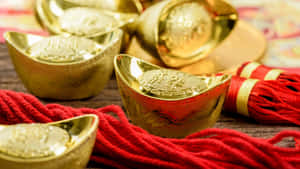 Gold Ingots With Red Ropes Wallpaper