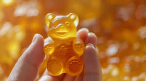 Golden Gummy Bear Heldin Hand Wallpaper