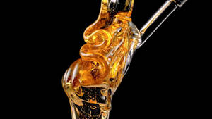 Golden Liquid Delight - A Close-up View Of Honey Wallpaper