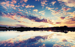 Golden Sunset Reflection Over Tranquil Waters Wallpaper