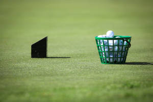 Golf Ball Basket On Golf Course Wallpaper