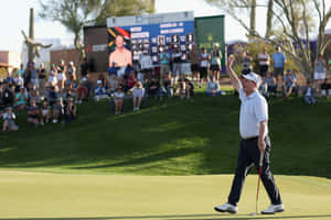 Golfer Celebrating Successful Putt Wallpaper