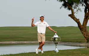 Golfer Celebrating Victory With Trophy Wallpaper