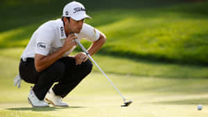 Golfer Evaluating Puttat The Players Championship Wallpaper