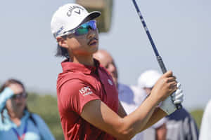 Golfer Focused During Swing Wallpaper