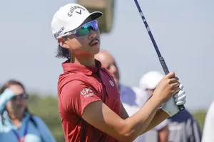 Golfer Focused During Swing Wallpaper