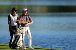 Golferand Caddie Contemplating Next Shot Wallpaper