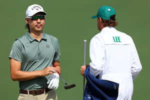 Golferand Caddie Strategy Discussion Wallpaper
