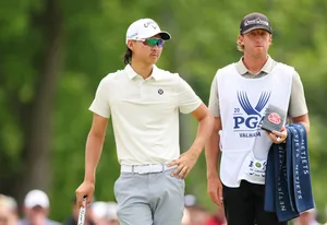 Golferand Caddie Walkingon Course Wallpaper