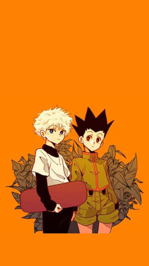 Gon And Killua Swapping Their Adventure Memories Through Their Phones Wallpaper