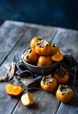 Gorgeous Bowl Of Persimmon Fruit Wallpaper