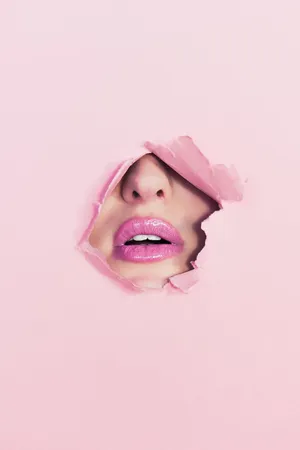 Gorgeous Woman Applying Stunning Pink Lipstick Wallpaper