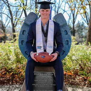 Graduate Athletewith Footballand Horseshoe Wallpaper