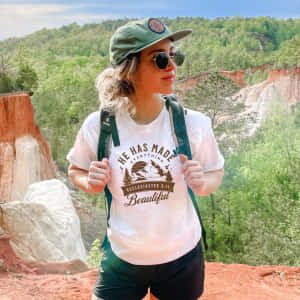 Granola Aesthetic_ Hiker With Inspirational Shirt_ Forest Backdrop Wallpaper