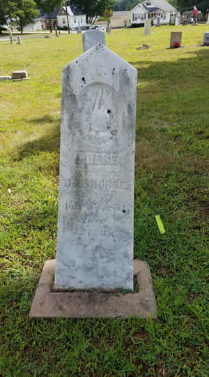 Gravestone Standing Tall Amidst Whispers Of The Past Wallpaper