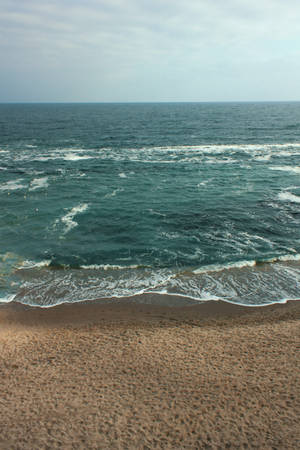 Gray Skies And A Lonely Beach. Wallpaper