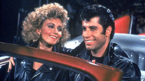 Grease John And Olivia Matching Jacket Wallpaper