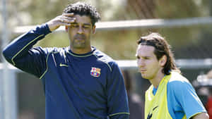 Great Athletes Frank Rijkaard And Lionel Messi Wallpaper