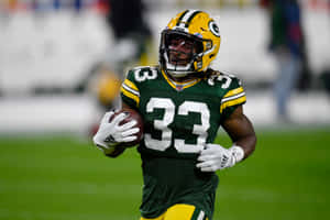 Green Bay Packers #33 Aaron Jones Runs For A Touchdown Wallpaper