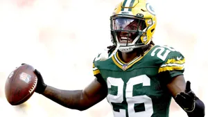 Green Bay Packers Player Celebratingwith Football Wallpaper