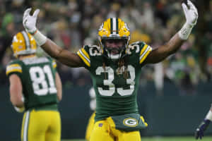 Green Bay Packers Running Back Aaron Jones Celebrates A Touchdown Wallpaper