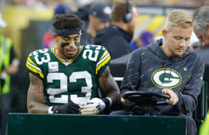 Green Bay Playerand Trainer Sideline Moment Wallpaper