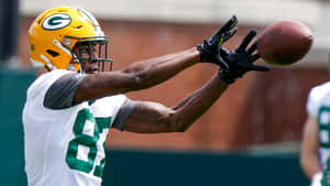 Green Bay Receiver Catching Football Practice Wallpaper