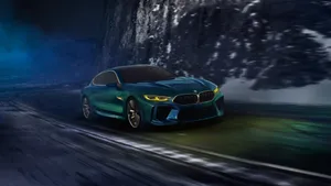 Green Coupe Speeding Past Mountain Wallpaper