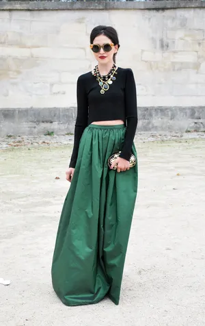 Green Fashion Model Wearing Sophisticated Eco-friendly Outfit Wallpaper