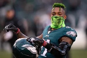 Green Haired Football Playerwith Helmet Wallpaper