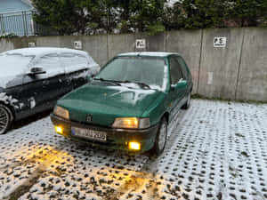 Green Peugeot106in Snow Wallpaper