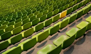Green Seats With A Yellow Conspicuous Chair Wallpaper