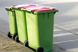 Green Wheelie Trash Can With Red Lid Wallpaper