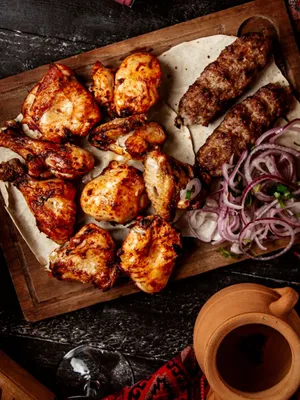 Grilled Meat Feast Dark Background Wallpaper