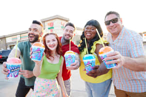 Group Enjoying Slurpees Outdoors Wallpaper